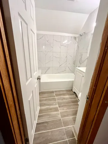 a bathroom with a bathtub and shower