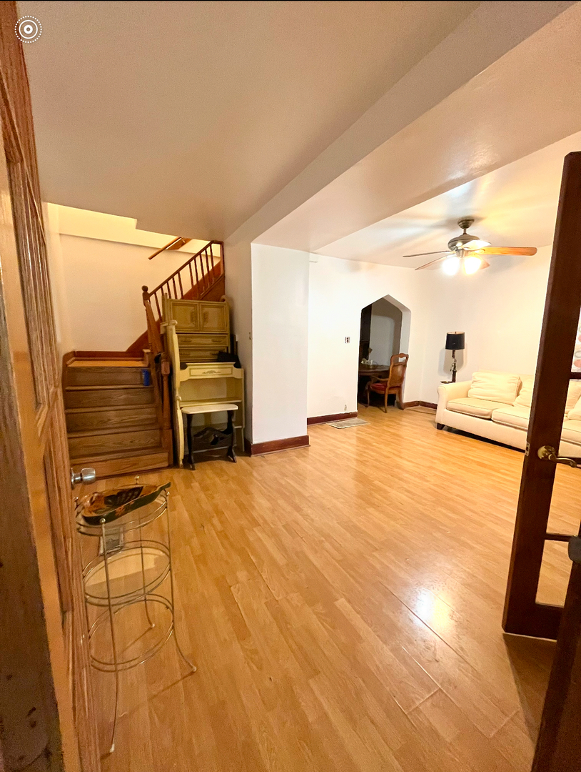 19 South Waller Avenue Chicago, IL 60644 - Photo 5 of 16 a view of a bedroom with wooden floor and furniture