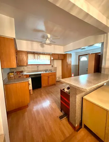 a kitchen with stainless steel appliances granite countertop a sink a stove and a refrigerator