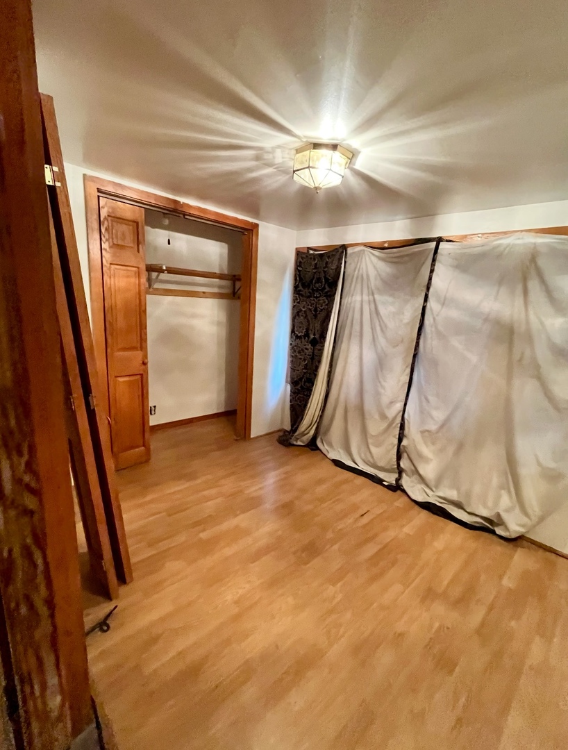 19 South Waller Avenue Chicago, IL 60644 - Photo 9 of 16 a view of an empty room with wooden floor