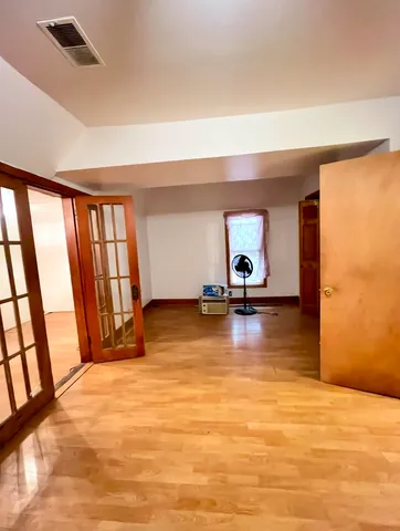 a view of a room with window and hardwood floor