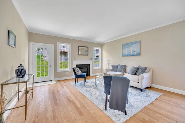 a living room with furniture a dining table and a fireplace