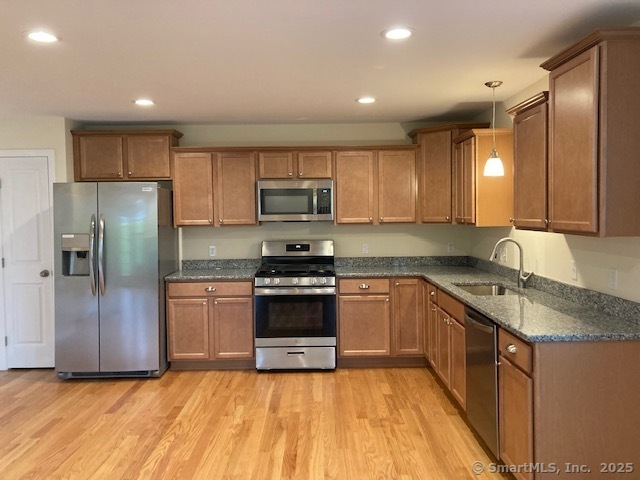 137 Webster Lane, Unit 242 Middletown, CT 06457 - Photo 2 of 17 a kitchen with stainless steel appliances granite countertop a refrigerator a sink a stove a microwave and island