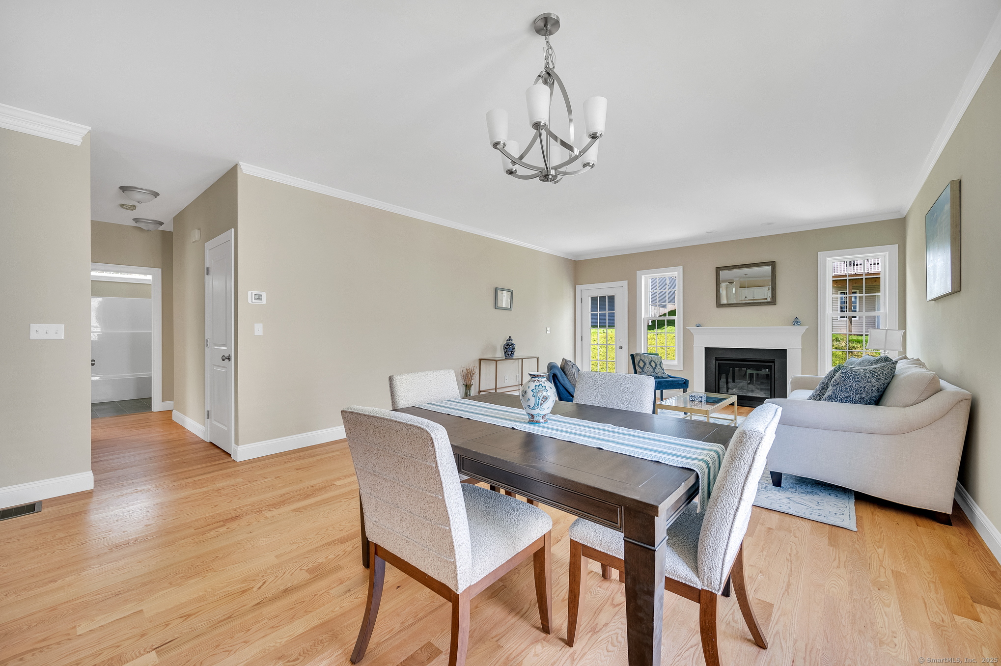 137 Webster Lane, Unit 242 Middletown, CT 06457 - Photo 5 of 17 a view of a dining room with furniture wooden floor and a chandelier