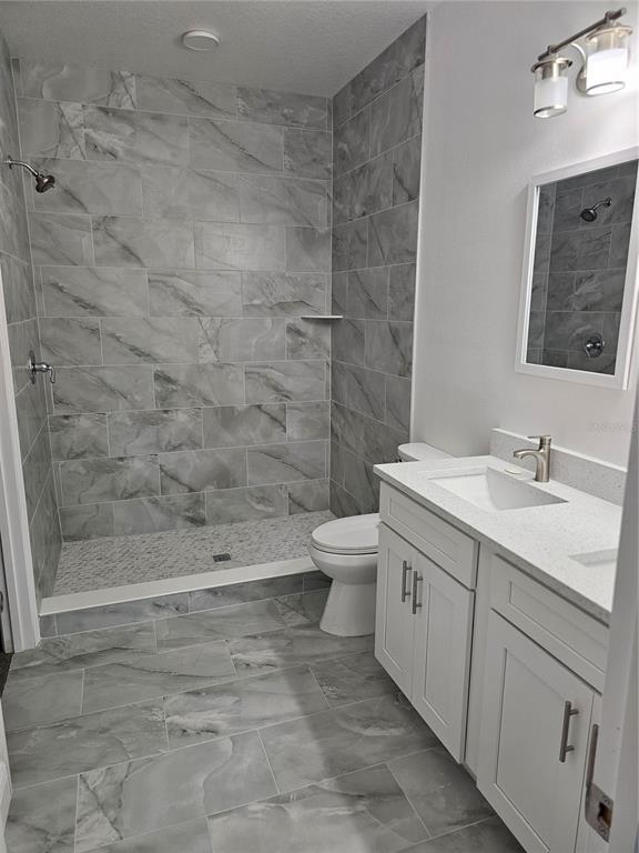 1171 Pine Street Altamonte Springs, FL 32701 - Photo 12 of 14 a bathroom with a granite countertop sink toilet and shower