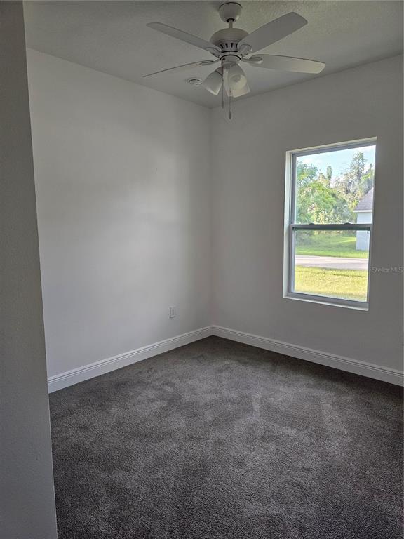 1171 Pine Street Altamonte Springs, FL 32701 - Photo 6 of 14 an empty room with a window and a fan
