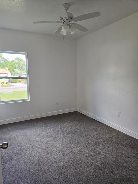 1171 Pine Street Altamonte Springs, FL 32701 - Photo 9 of 14 an empty room with a window and a fan