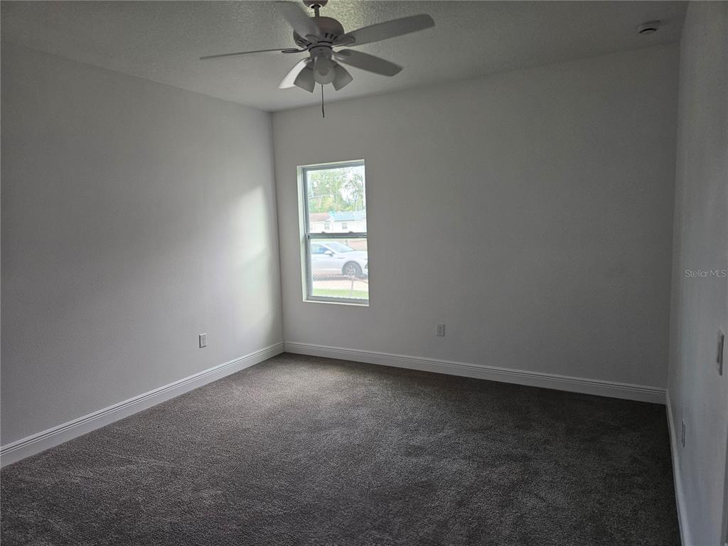 1171 Pine Street Altamonte Springs, FL 32701 - Photo 10 of 14 an empty room with a window and a fan