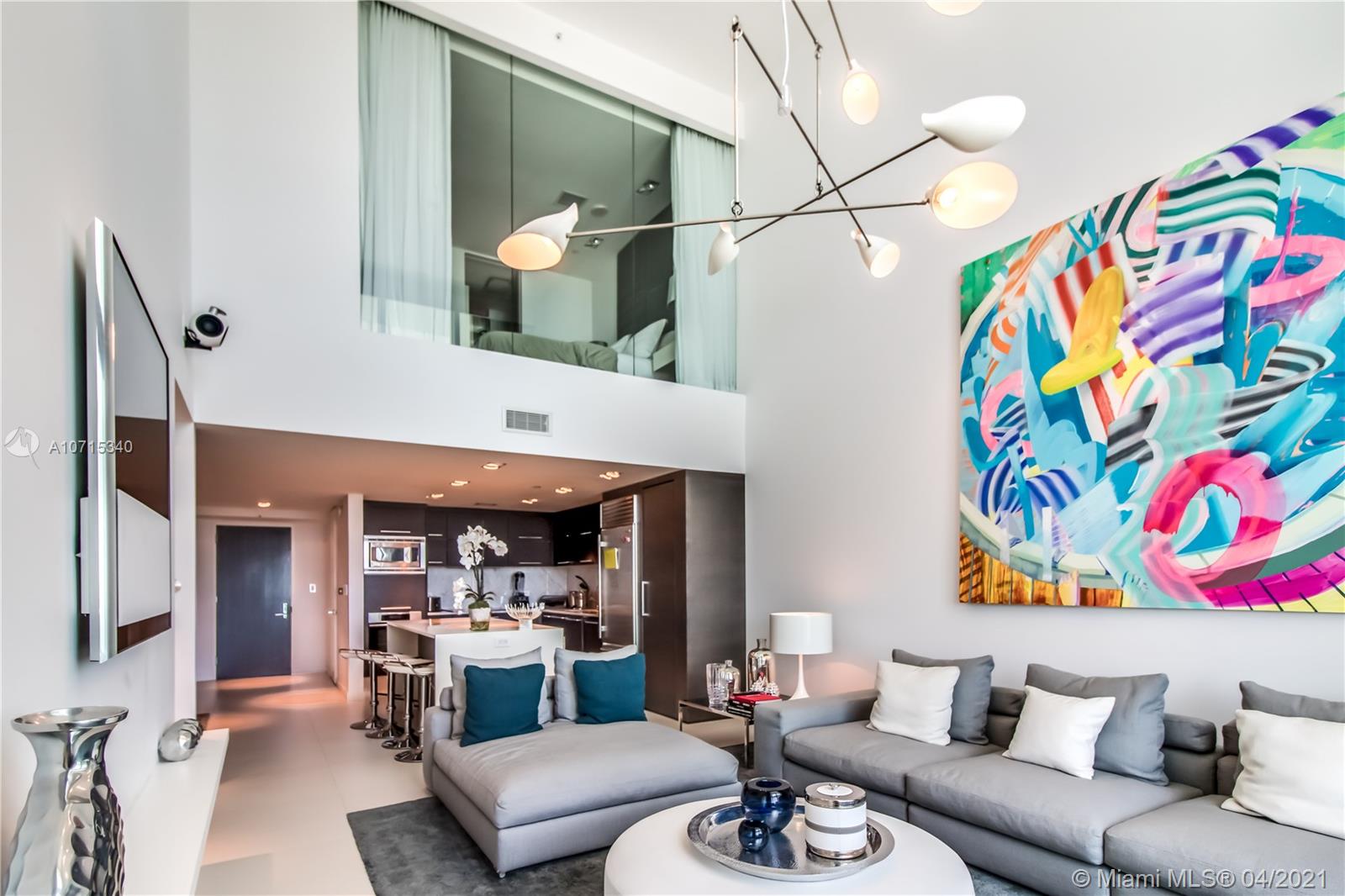 900 Biscayne Boulevard, Unit 705 Miami, FL 33132 - Photo 2 of 43 a living room with furniture and a chandelier