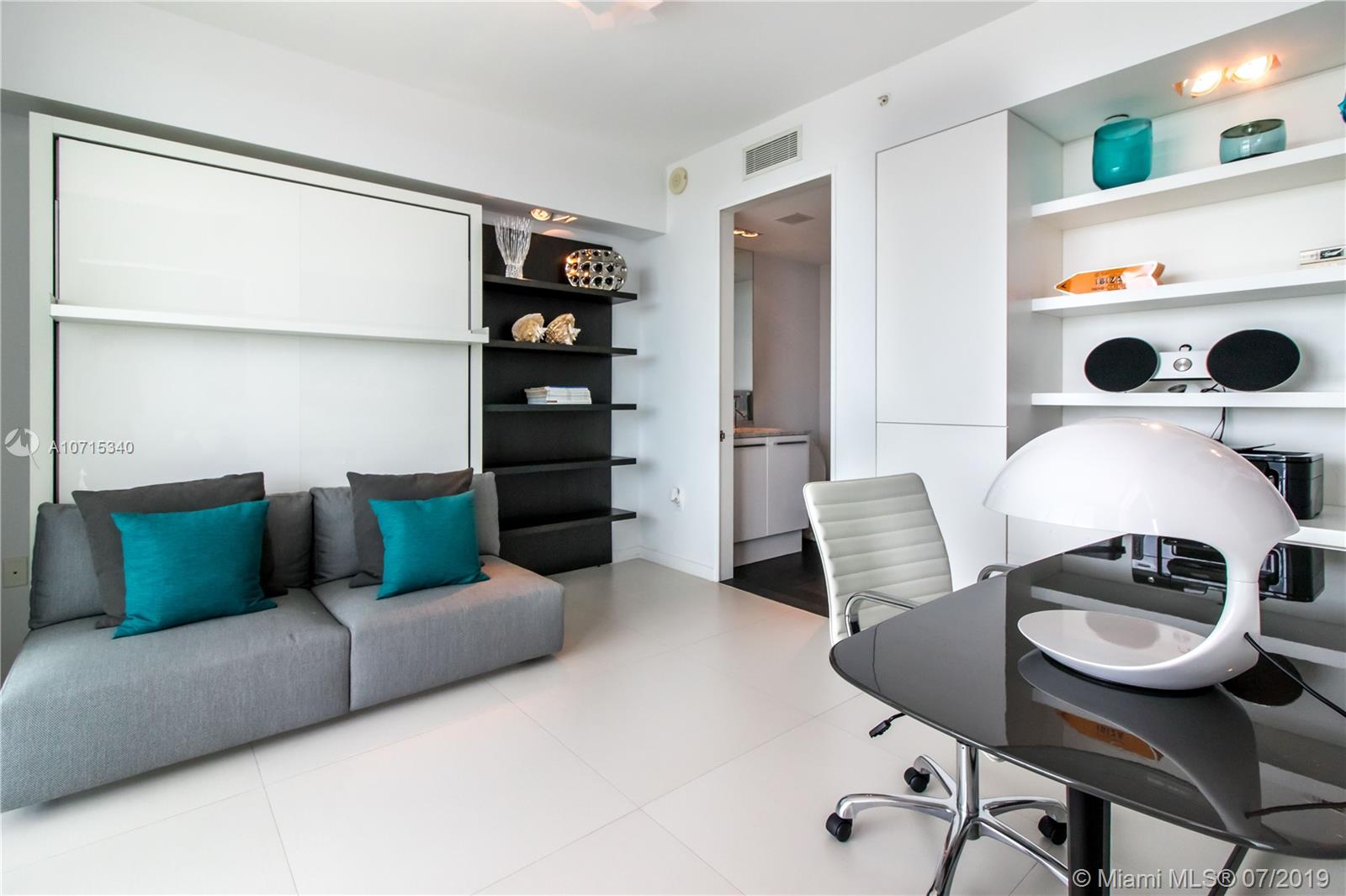 900 Biscayne Boulevard, Unit 705 Miami, FL 33132 - Photo 17 of 43 a living room with furniture and a wooden floor