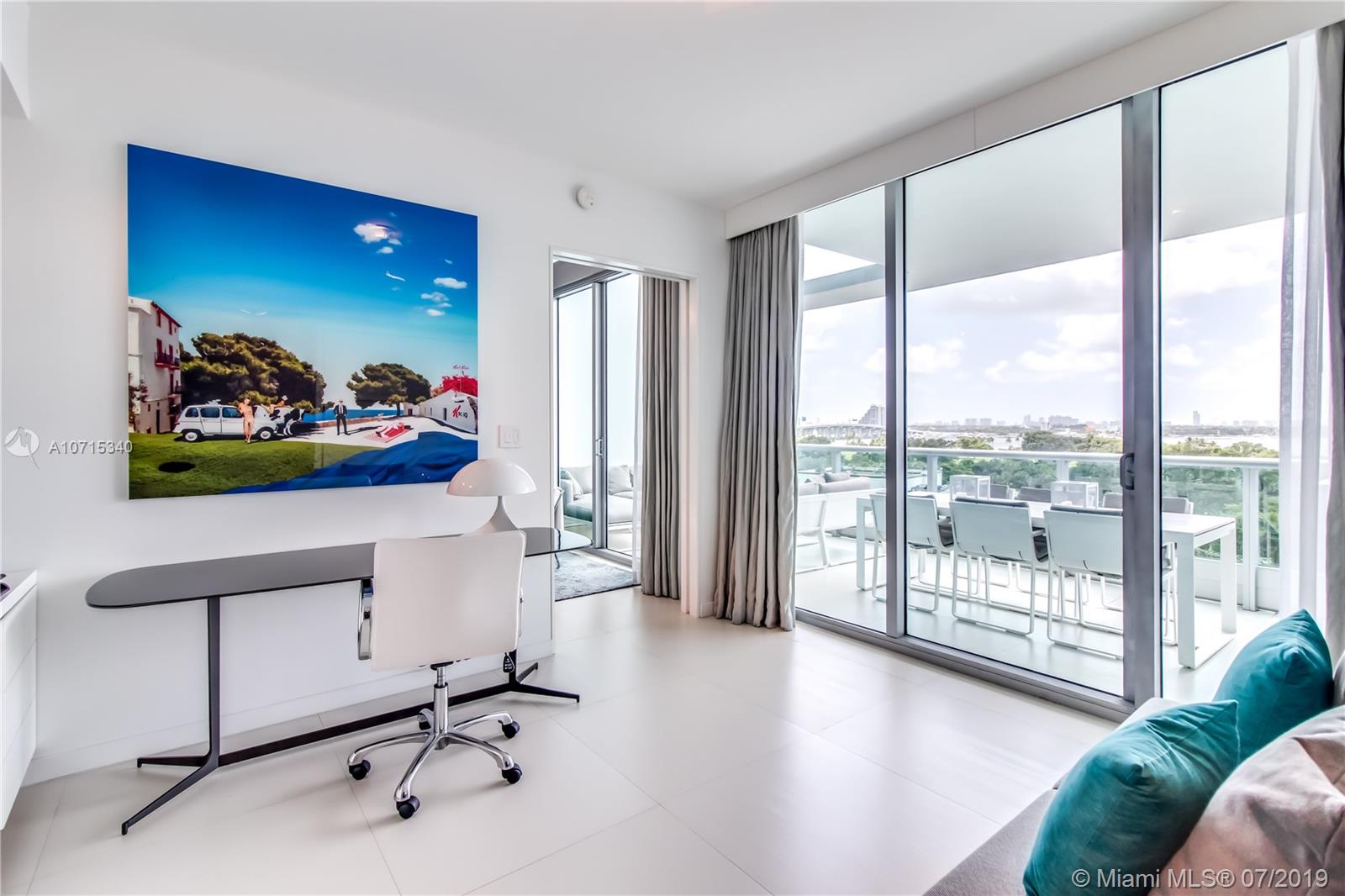 900 Biscayne Boulevard, Unit 705 Miami, FL 33132 - Photo 19 of 43 a view of a workspace with furniture and a large window