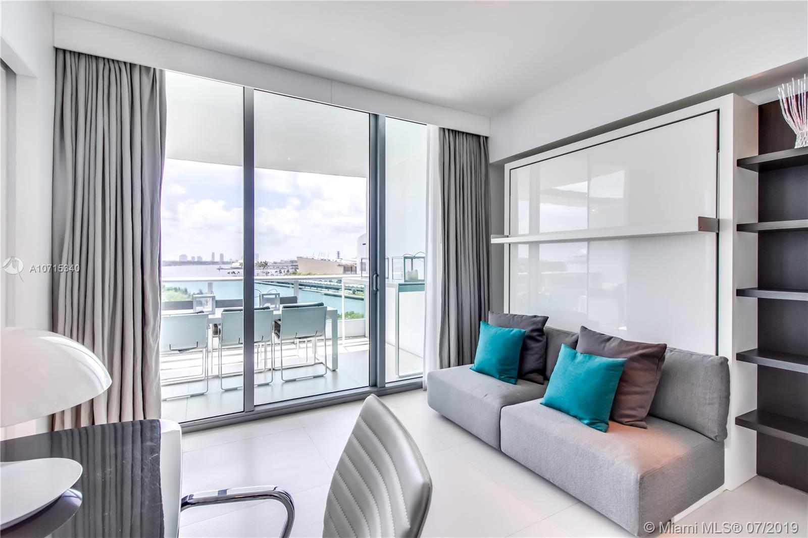 900 Biscayne Boulevard, Unit 705 Miami, FL 33132 - Photo 21 of 43 a living room with furniture and a large window