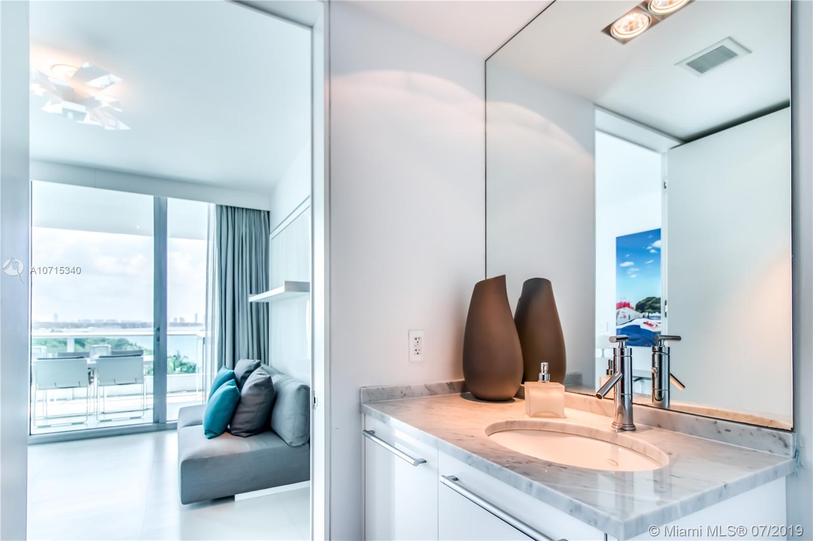 900 Biscayne Boulevard, Unit 705 Miami, FL 33132 - Photo 22 of 43 a living room with furniture and a large window