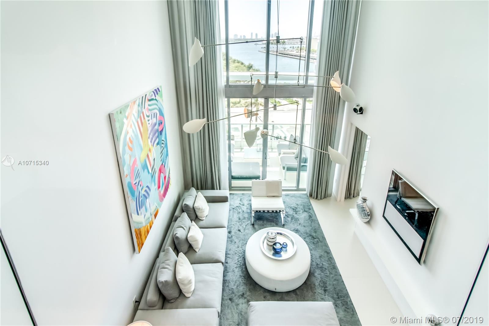 900 Biscayne Boulevard, Unit 705 Miami, FL 33132 - Photo 25 of 43 a dining room with furniture and wooden floor