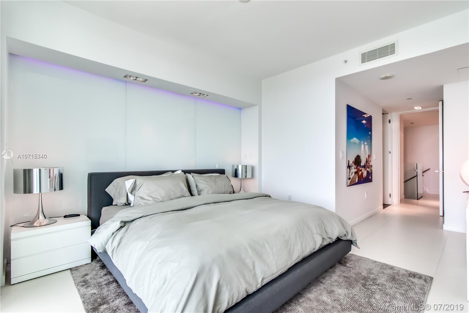 900 Biscayne Boulevard, Unit 705 Miami, FL 33132 - Photo 30 of 43 a bedroom with a large bed and a couch