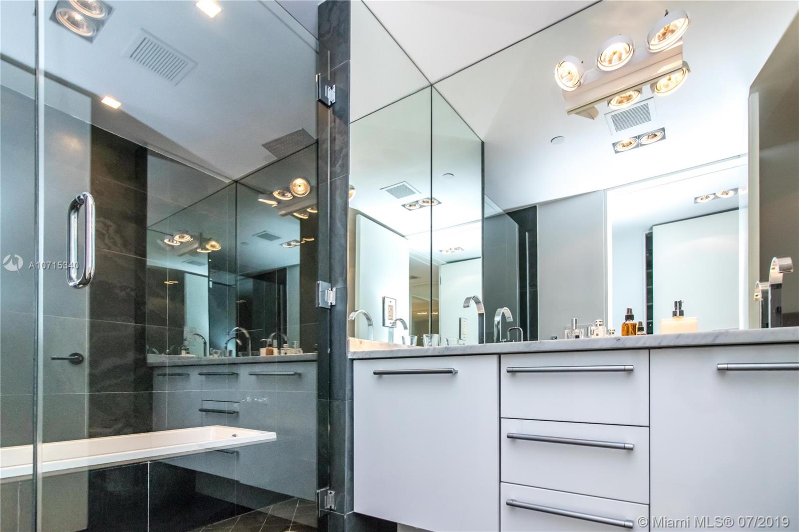 900 Biscayne Boulevard, Unit 705 Miami, FL 33132 - Photo 32 of 43 a bathroom with a sink and a mirror