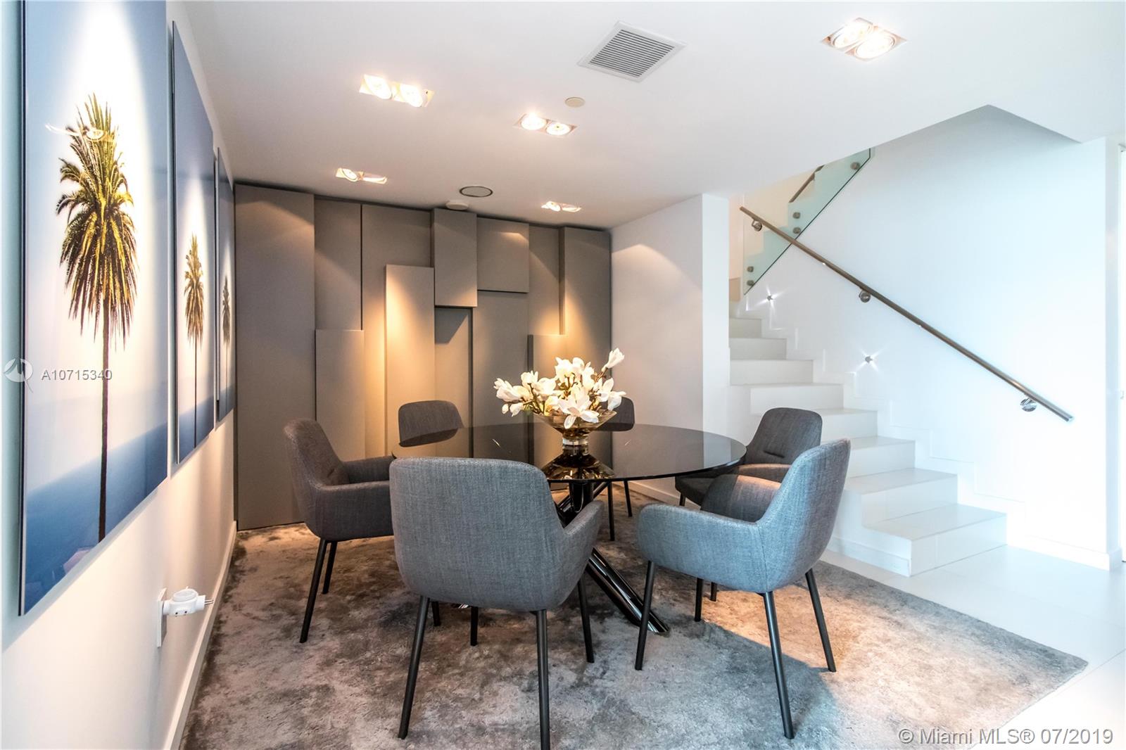 900 Biscayne Boulevard, Unit 705 Miami, FL 33132 - Photo 7 of 43 a dining room with furniture and a chandelier