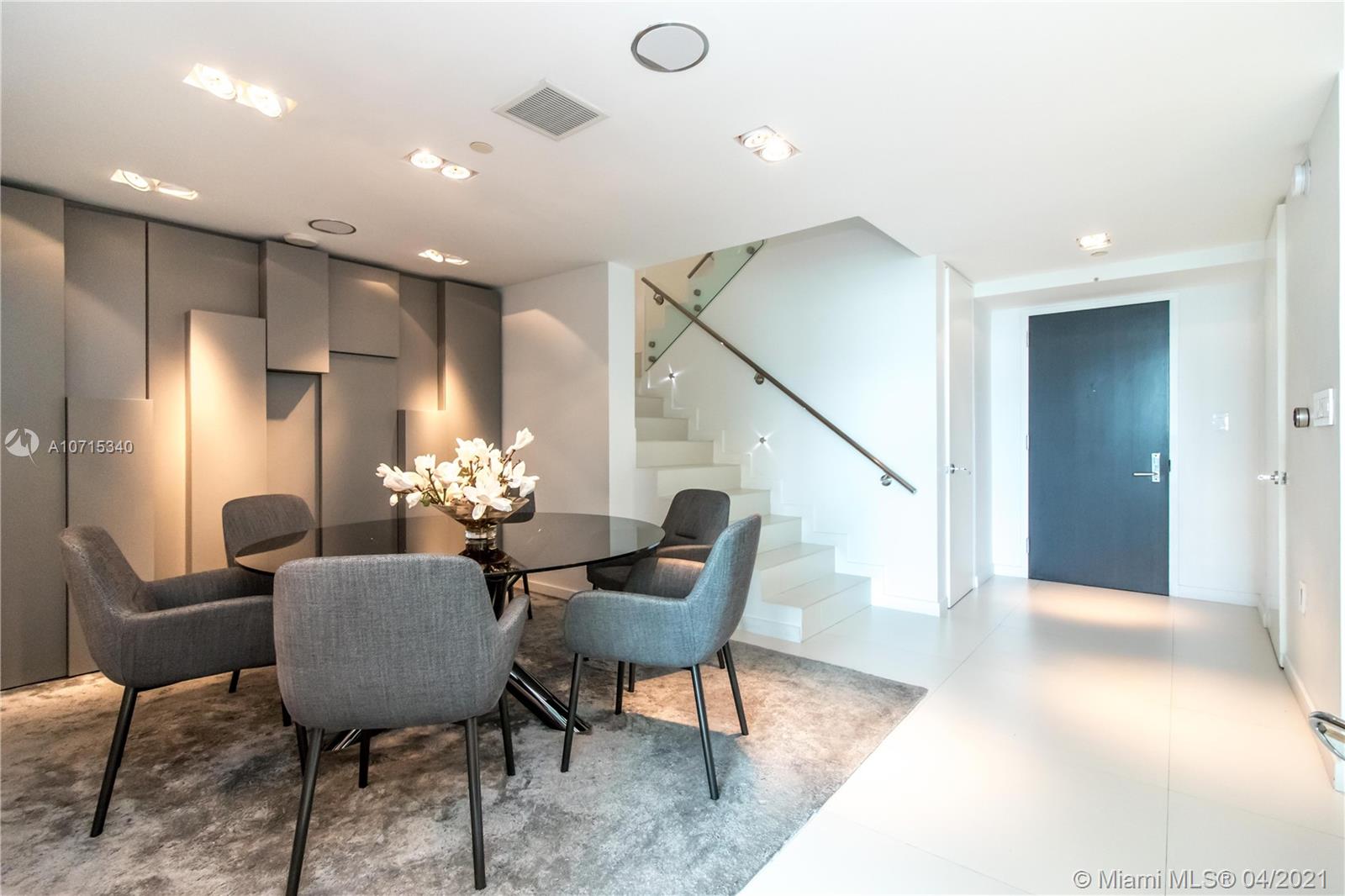 900 Biscayne Boulevard, Unit 705 Miami, FL 33132 - Photo 8 of 43 a dining room with furniture and wooden floor