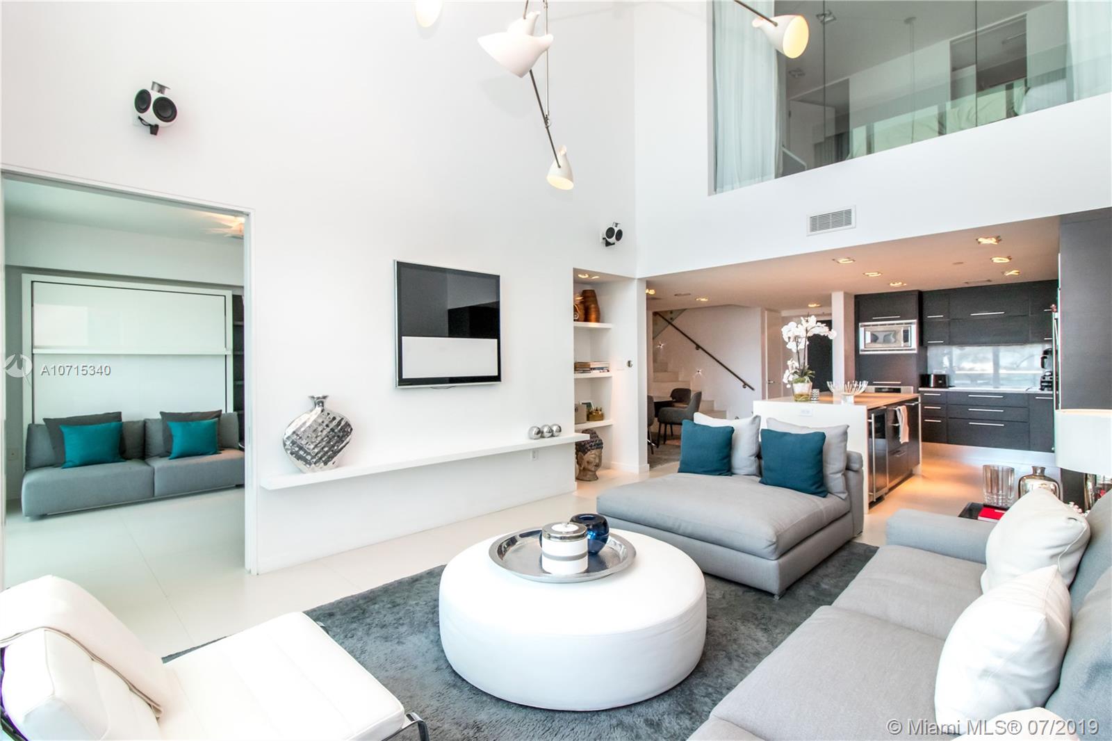 900 Biscayne Boulevard, Unit 705 Miami, FL 33132 - Photo 10 of 43 a living room with furniture and a wooden floor