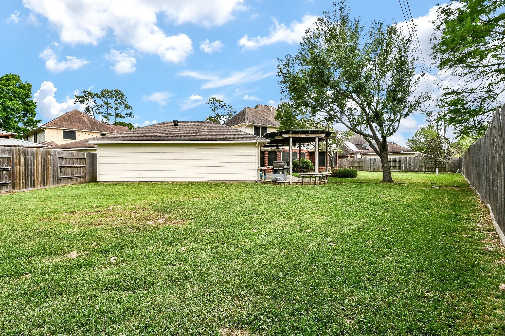 20423 Forest Drive Spring, TX 77388 - Photo 10 of 44 Spacious backyard area located behind the garage, offering endless possibilities for landscaping, gardening, or outdoor recreation.
