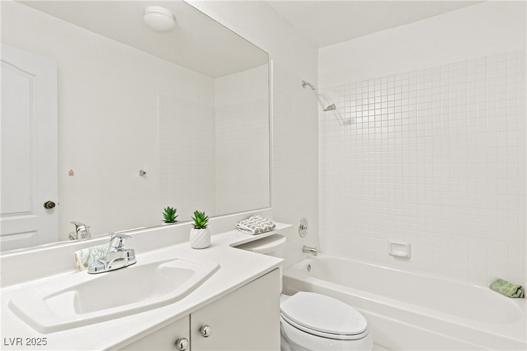 7620 Rolling View Drive, Unit 101 Las Vegas, NV 89149 - Photo 20 of 30 ~YOUR 2ND FULL BATHROOM HAS A TUB/SHOWER COMBO WITH TILED SURROUND~NEW FAUCETS~VANITY BELOW FOR STORAGE~TILED FLOORS~