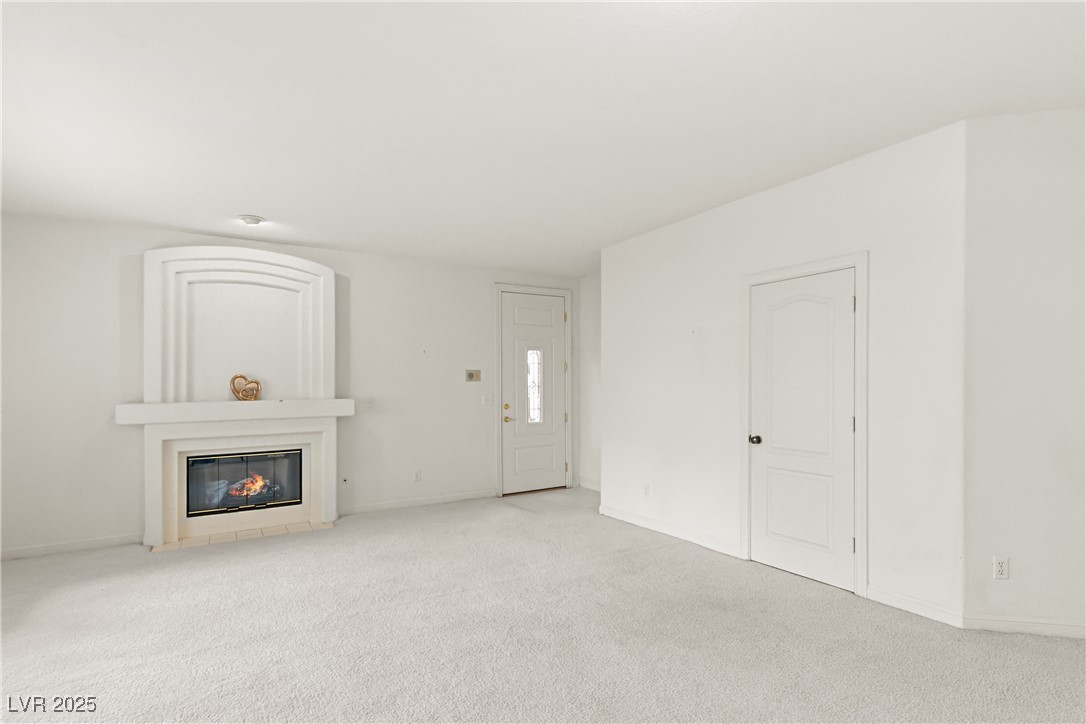 7620 Rolling View Drive, Unit 101 Las Vegas, NV 89149 - Photo 8 of 30 ~YOUR NEW GREAT ROOM HAS ALOT OF FEATURES FOR YOU TO ENJOY!~FRONT DOOR ENTRY WITH DESIGNER GLASS INSERT~GUEST CLOSET TO THE RIGHT~TILE ENTRY~AND ONE AMAZING FIRPLACE WITH A UNIQUE SURROUND AND MANTLE~