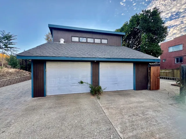 a view of a house with a yard and tree s