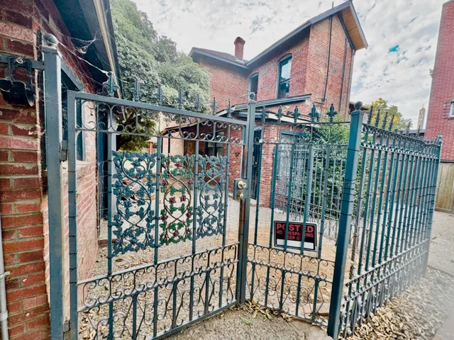 a kitchen with stainless steel appliances granite countertop a refrigerator a stove and a sink with wooden floor