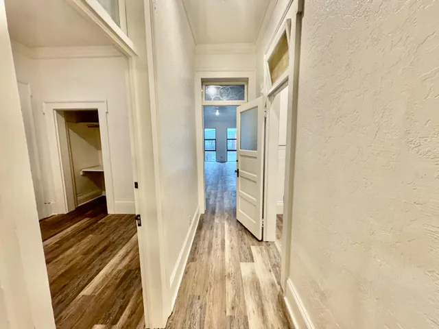 a view of room with window and wooden floor