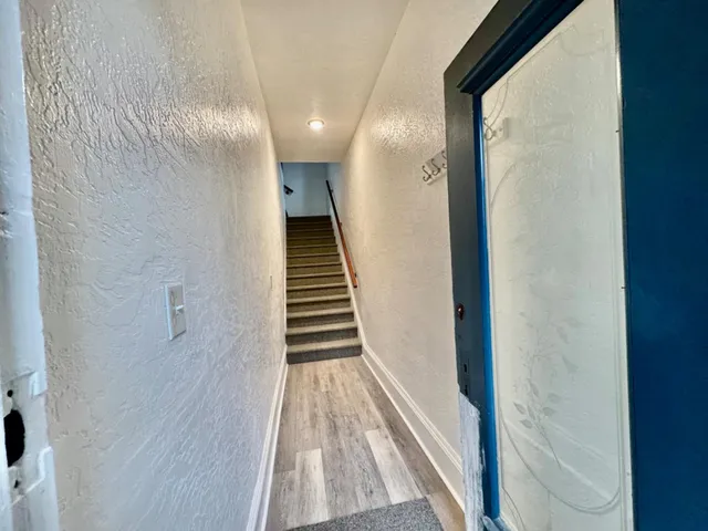 a view of a hallway with wooden floor