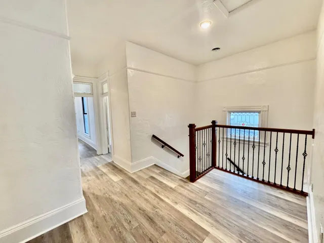 a view of a refrigerator in kitchen with white walls