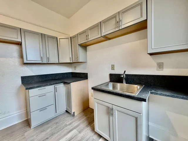 a view of a house with a yard and tree s