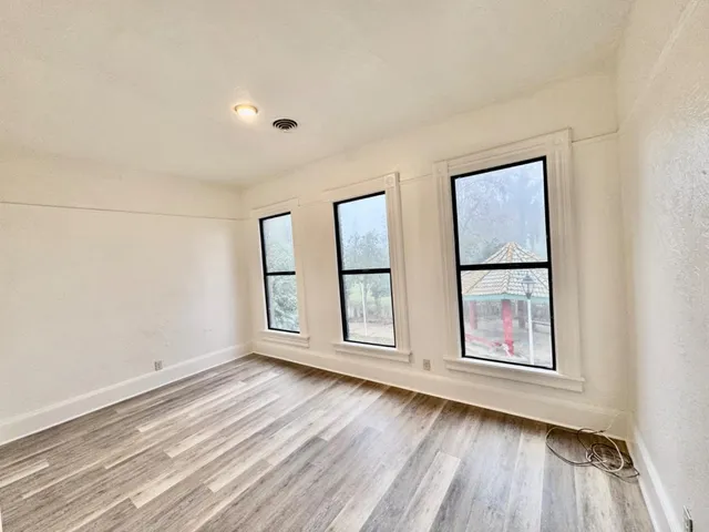 a front view of a house with a yard and black garage