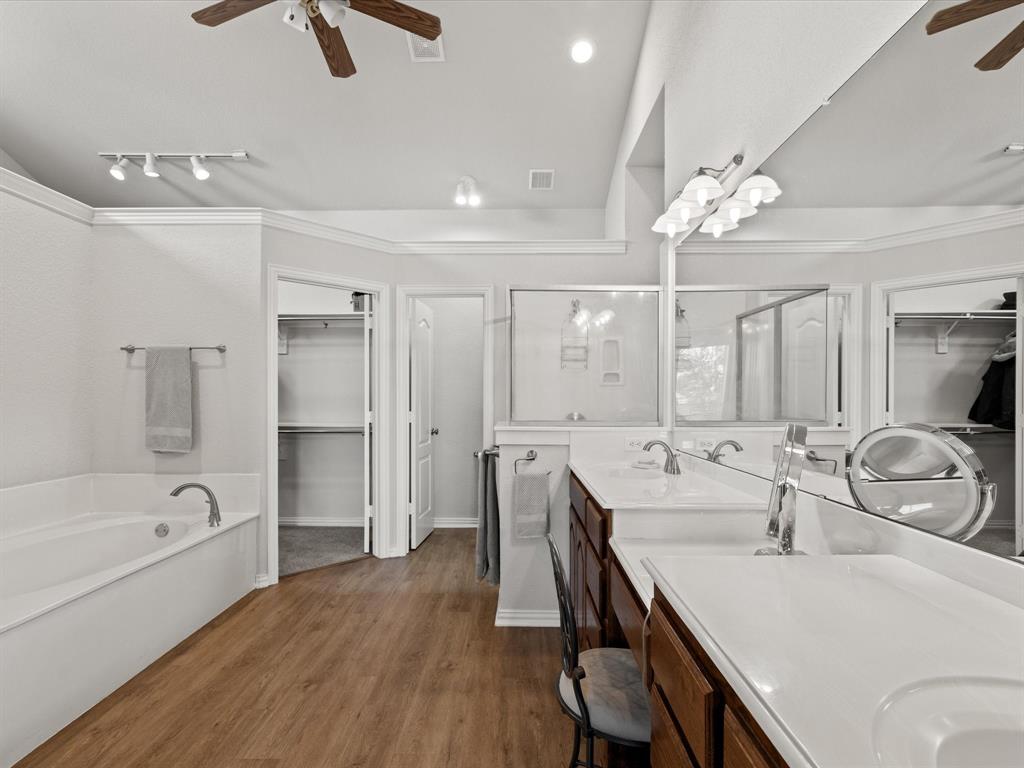 10066 Irish Ridge Forney, TX 75126 - Photo 11 of 39 Bathroom featuring a ceiling fan, a spacious closet, double vanity, a stall shower, and crown molding