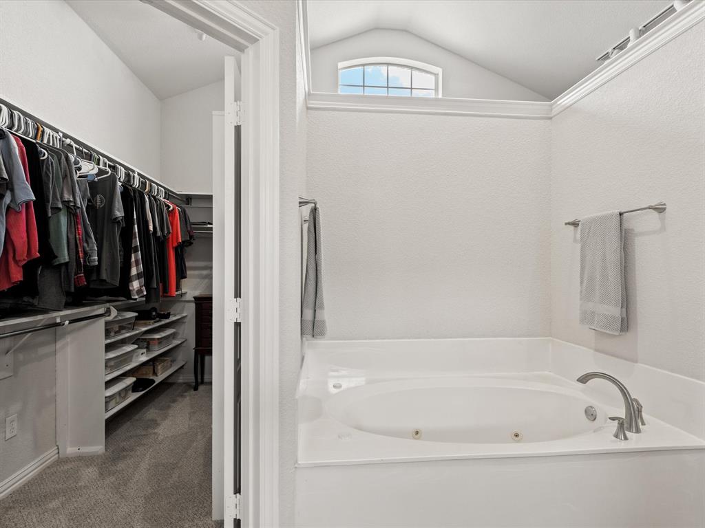 10066 Irish Ridge Forney, TX 75126 - Photo 13 of 39 Bathroom with vaulted ceiling, a tub with jets, and a spacious closet