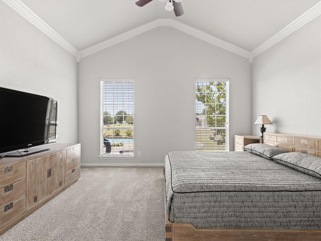 10066 Irish Ridge Forney, TX 75126 - Photo 17 of 39 Bedroom with carpet, multiple windows, lofted ceiling, and a ceiling fan