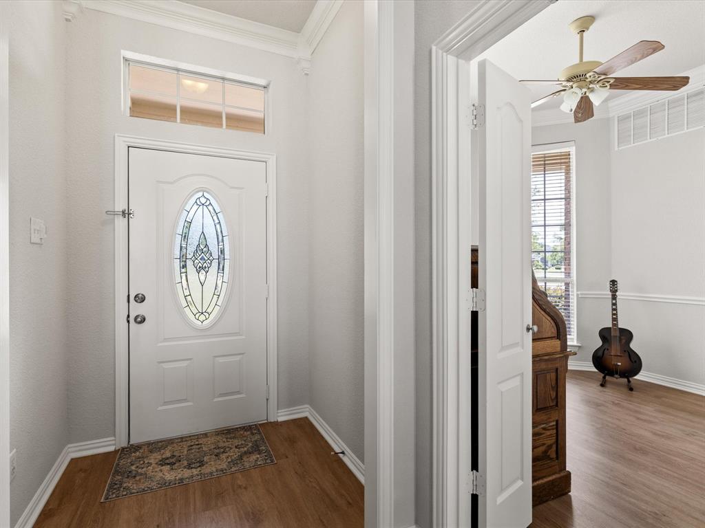 10066 Irish Ridge Forney, TX 75126 - Photo 31 of 39 Entrance foyer with dark wood-type flooring, crown molding, and ceiling fan