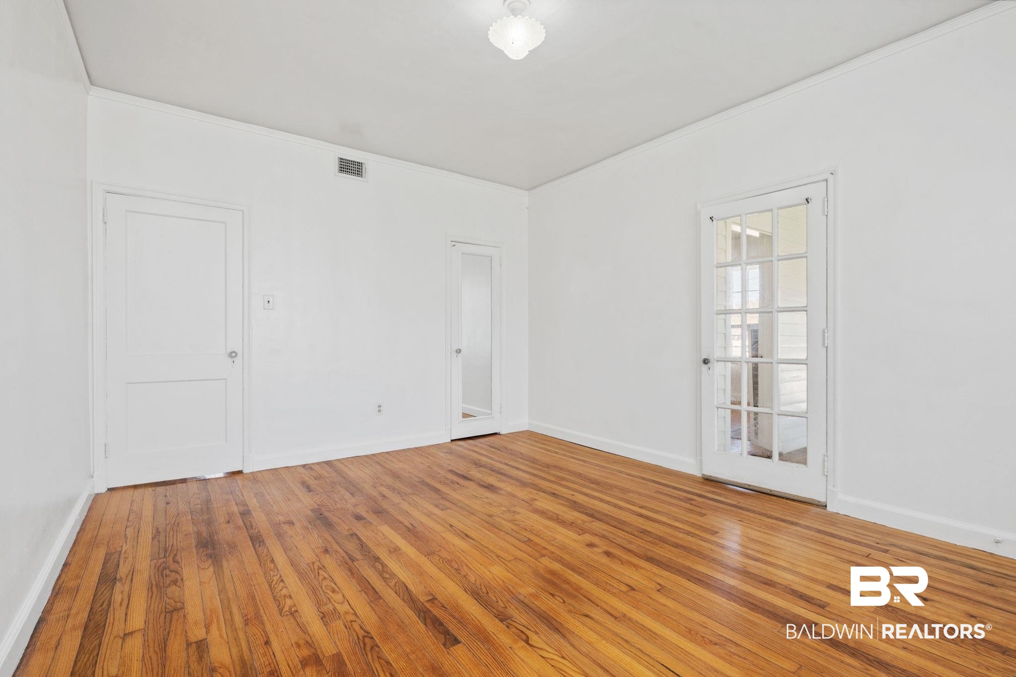 1707 Church Street Mobile, AL 36604 - Photo 13 of 43 Unfurnished room featuring hardwood / wood-style floors, baseboards, and visible vents