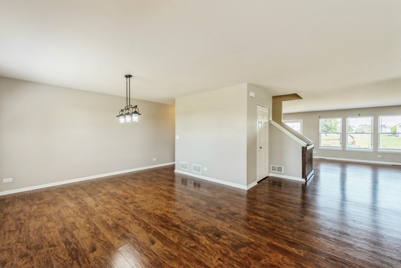 2204 Ridge Drive Hebron, IL 60034 - Photo 3 of 26 an empty room with wooden floor and window