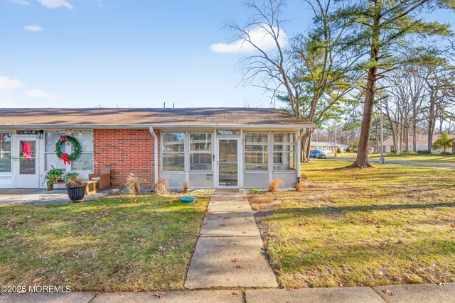 a front view of house with a garden and patio