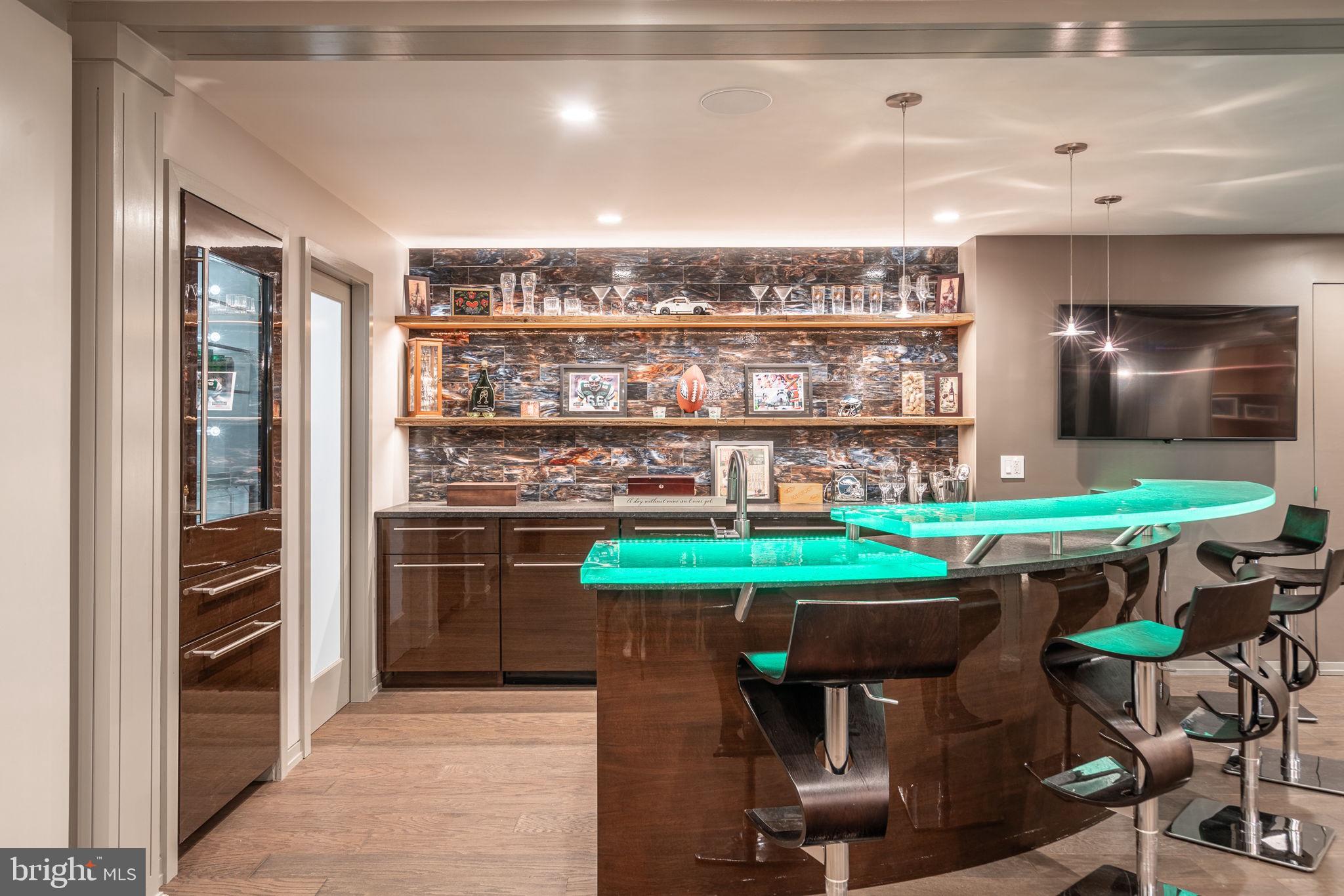 4104 Howell Road Malvern, PA 19355 - Photo 47 of 84 a kitchen with stainless steel appliances a table and chairs in it