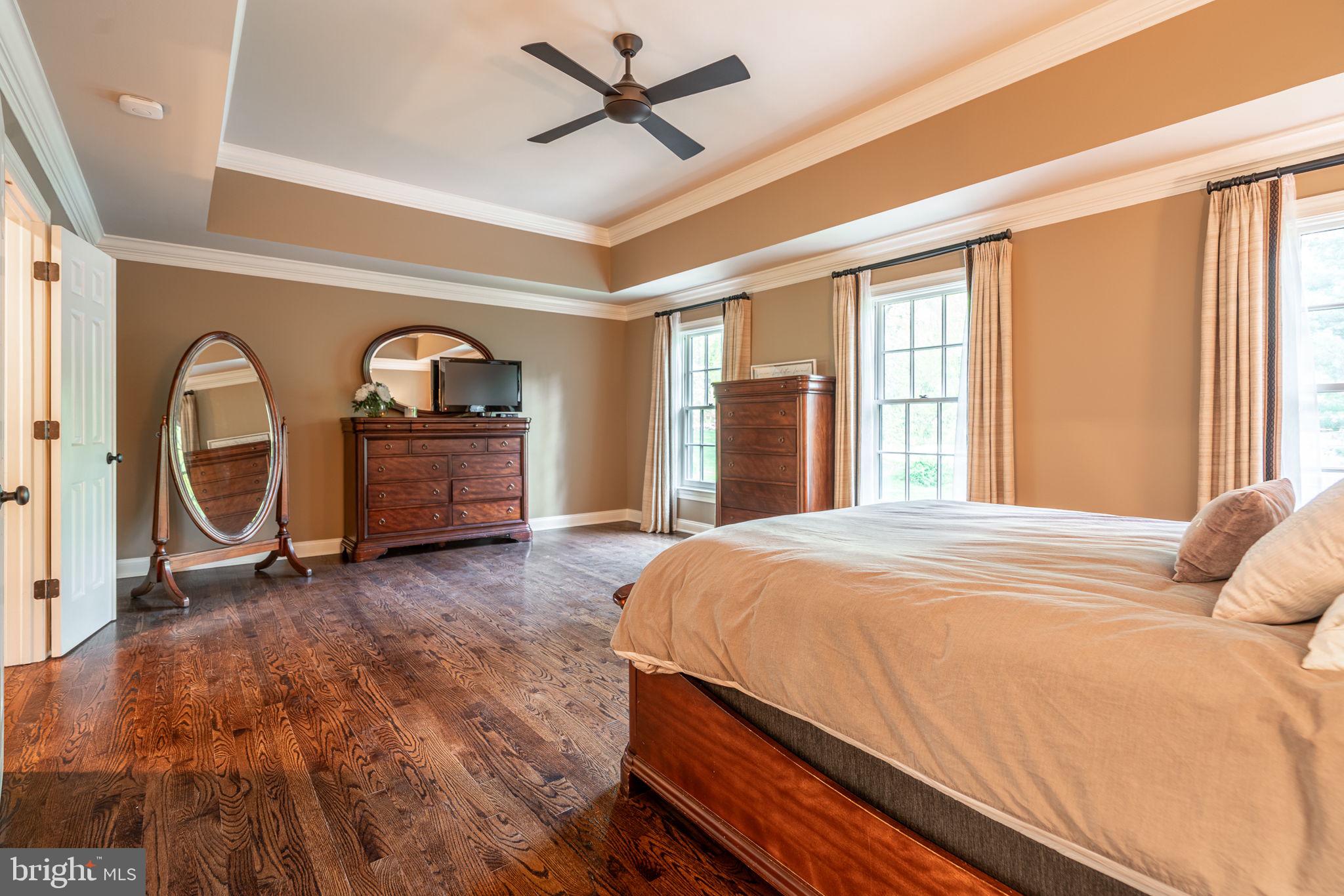 4104 Howell Road Malvern, PA 19355 - Photo 53 of 84 a bedroom with a bed next to a large window with wooden floor