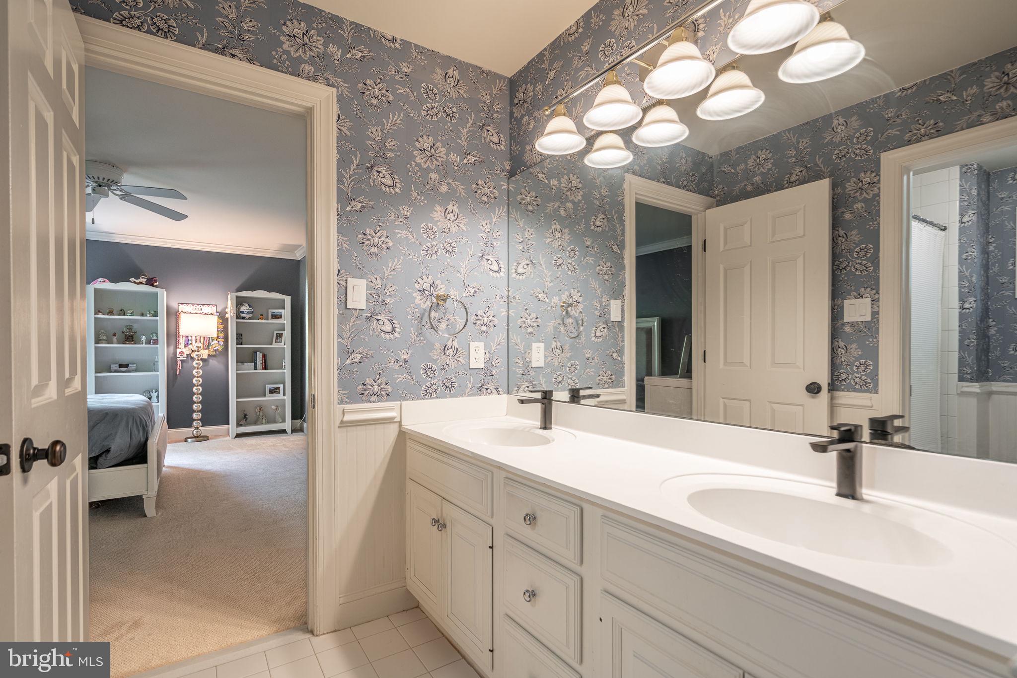 4104 Howell Road Malvern, PA 19355 - Photo 62 of 84 a spacious bathroom with a double vanity sink and a mirror