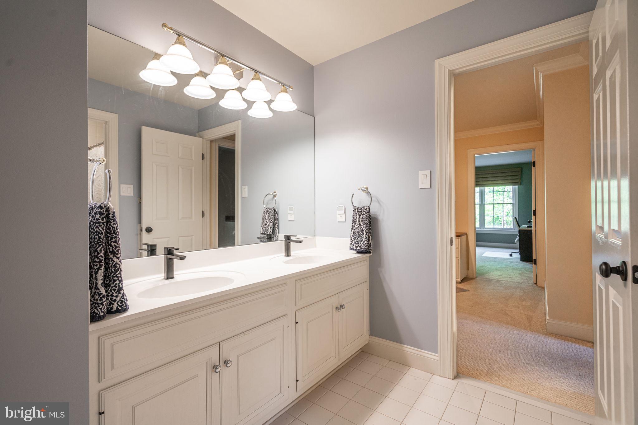 4104 Howell Road Malvern, PA 19355 - Photo 67 of 84 a spacious bathroom with a double vanity sink and a mirror