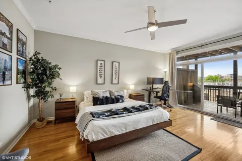 a bedroom with a large bed and a potted plant