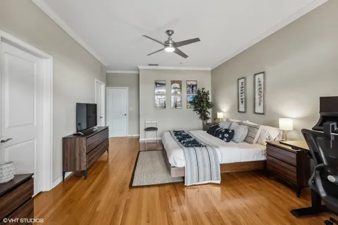 a bedroom with furniture and a wooden floor