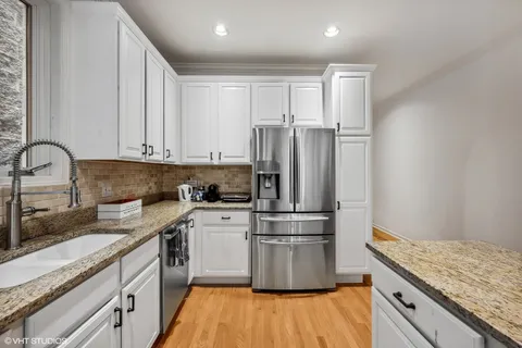 a kitchen with a refrigerator and a sink