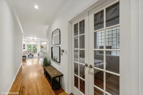 a view of a living room with wooden floor and windows