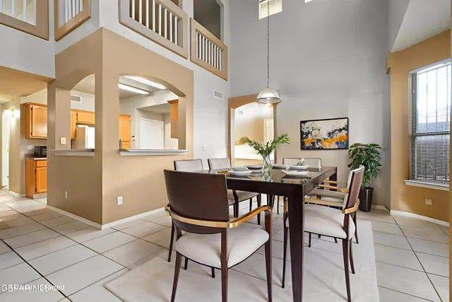 a view of a dining room with furniture and a chandelier
