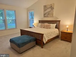 a bedroom with a bed and flat screen tv